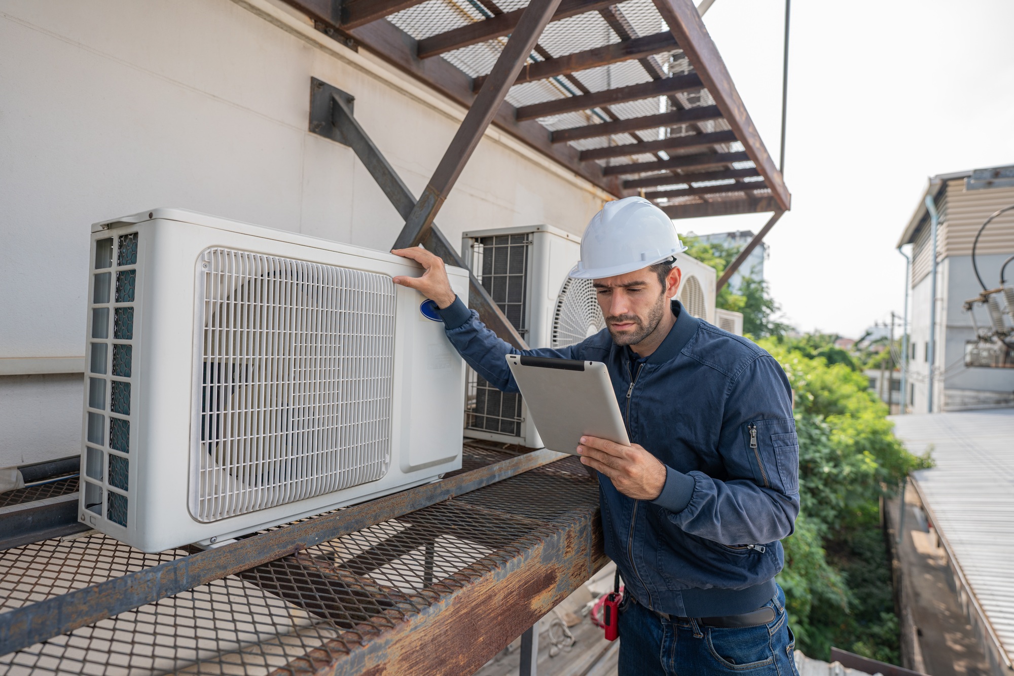 Air conditioner technician checking air conditioner operation.