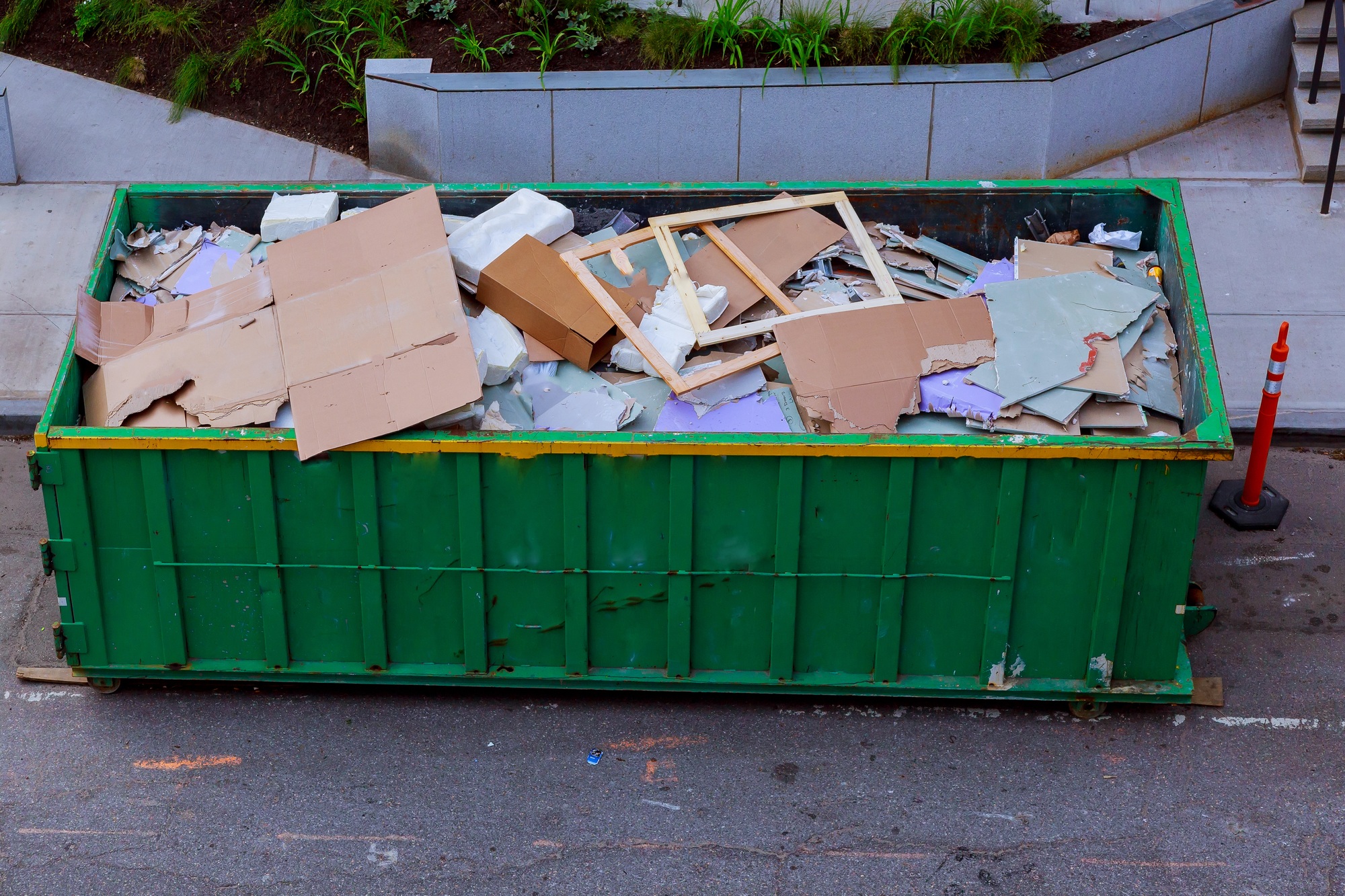 Construction waste in an metal container, home house renovation. container for construction waste